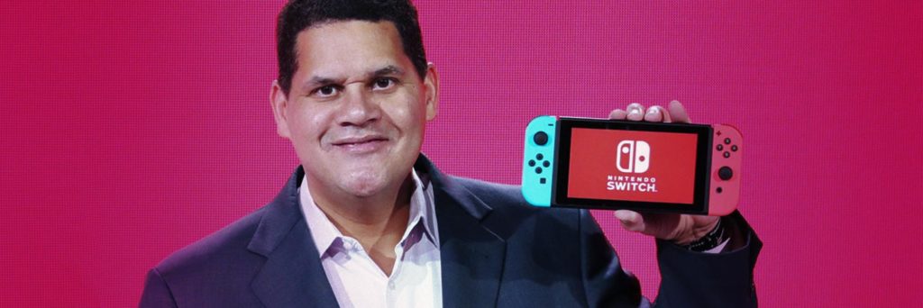 Reggie Fils Aime holds new nintendo switch alistdaily