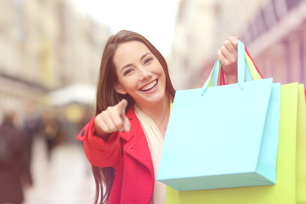 Photo of Girl Shopping and Happily Pointing Finger at Camera