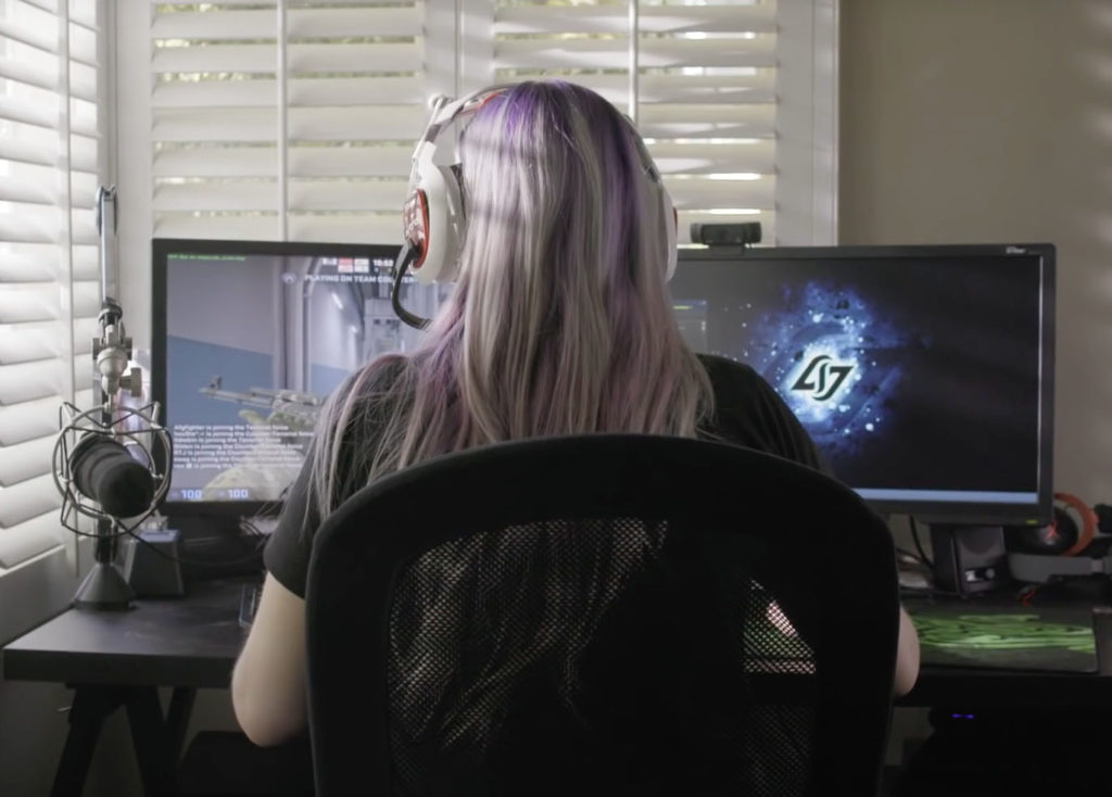 Stephanie Harvey games at her computer as her back is turned to the camera