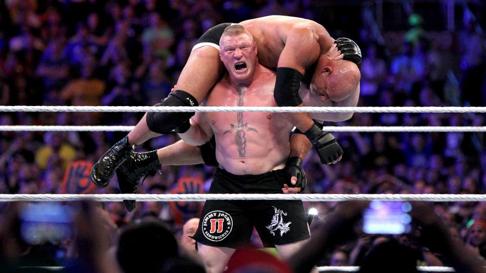 Photo of Brock Lesner Holding Man on his back in a Winning Champion Stance