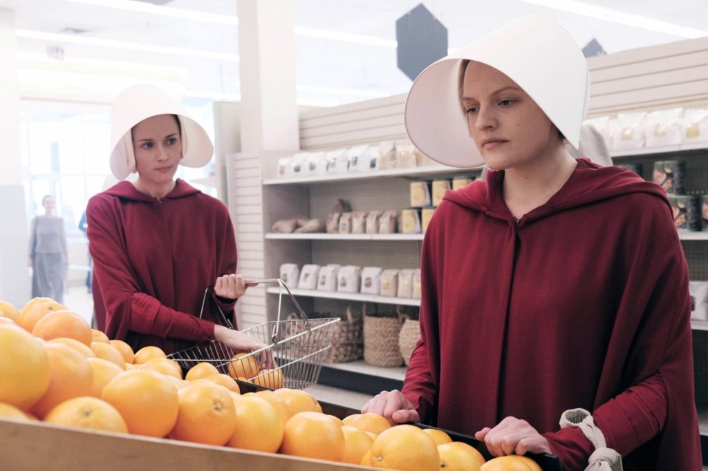 Elisabeth Moss Handmaid in Market picking oranges Photo by George Kraychyk