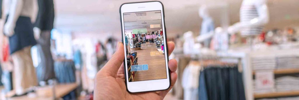 Hand holding smartphone with Augmented Reality shopping app
