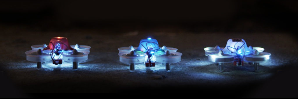 3 Tiny Whoop drones lined up in a row