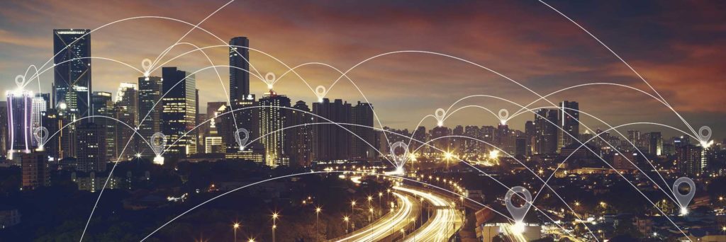 Image of City at sunset with graphic dropped pins scattered across city