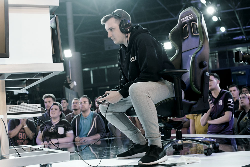 Esports player mid FIFA game on stage