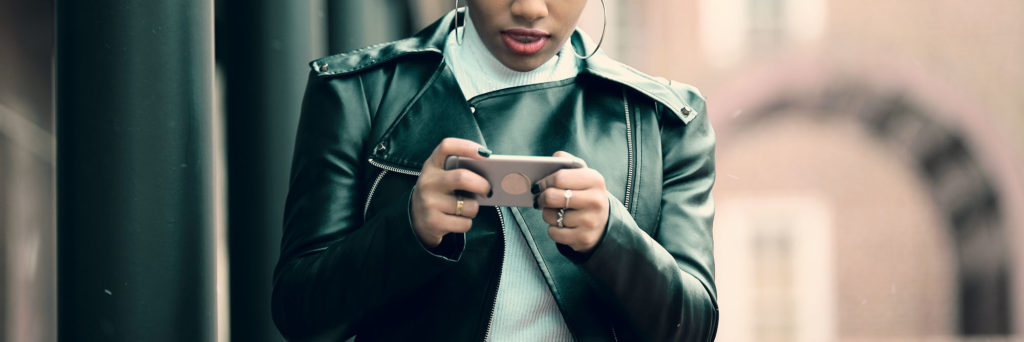 Young lady using phone to play games