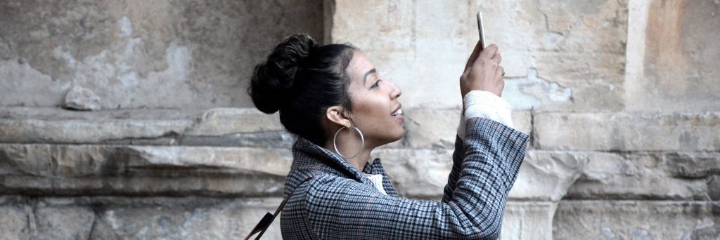 Millennial woman using phone to take a photo