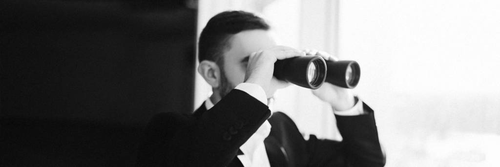 Business Man using binoculars to spy