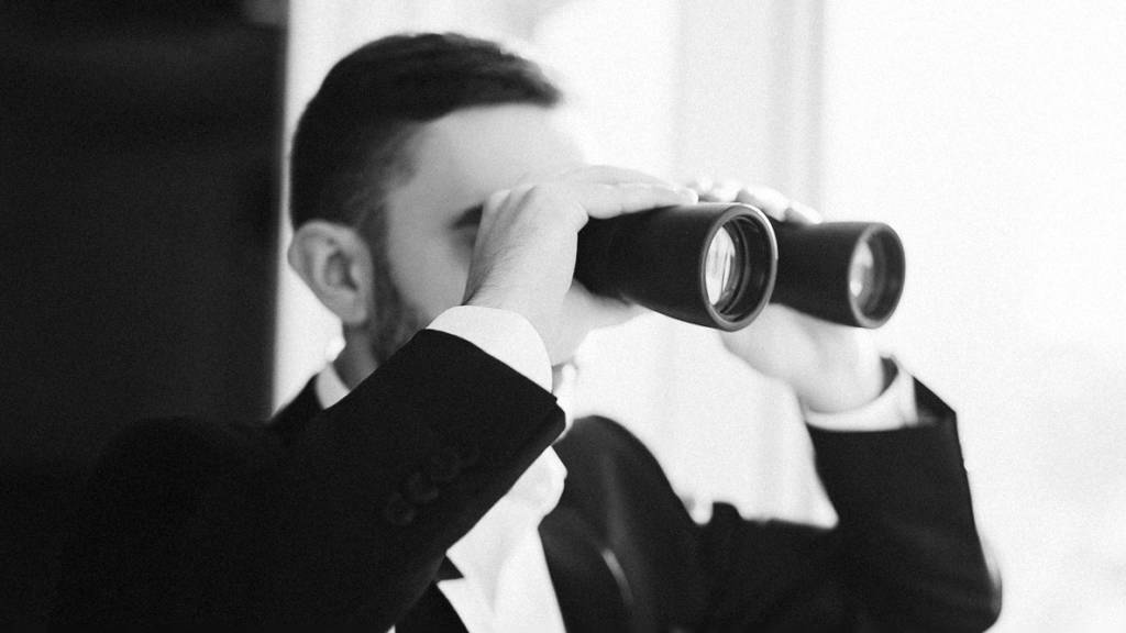 Business Man using binoculars to spy