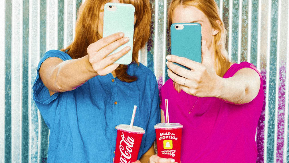 two women selfie while holding wendy's cups