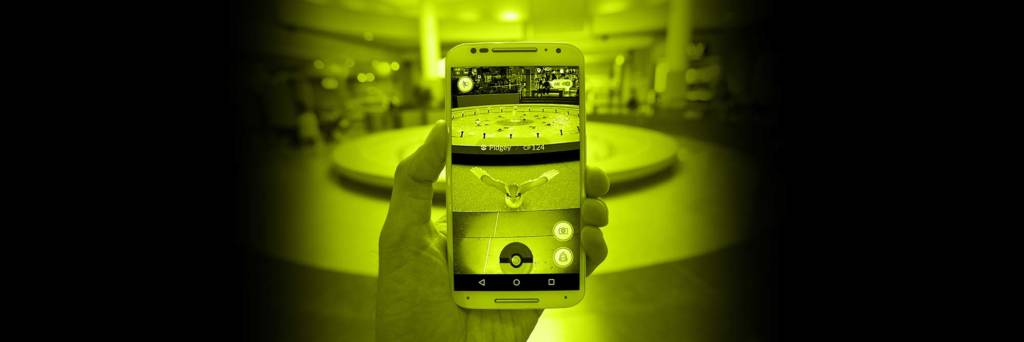 Hand holding phone with pokemon go game app open