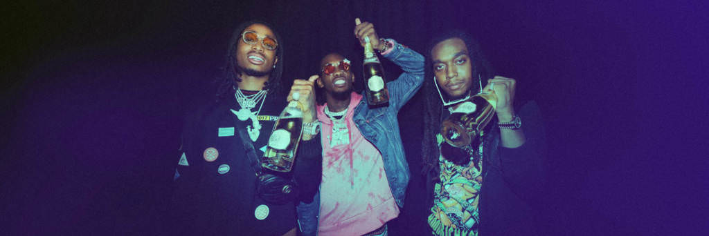 Migos rap group celebrating with champagne