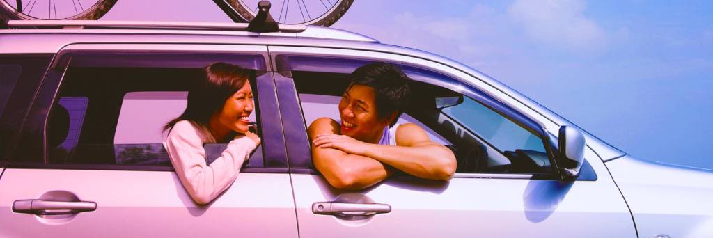 happy asian couple in car