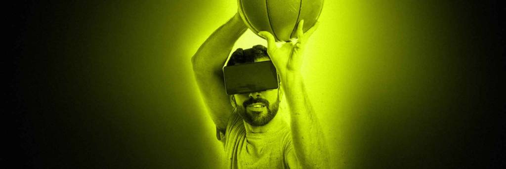 Man throws basketball while wearing a virtual reality headset