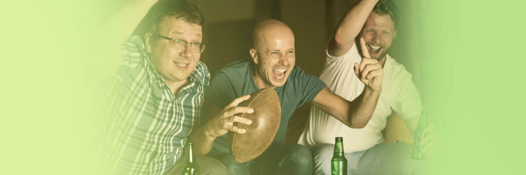 Men cheering at tv during superbowl